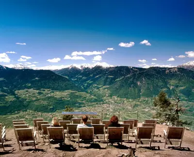 two people sitting in chairs on top of a mountain at Hotel Stamserhof in Andrian