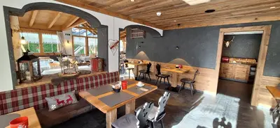 a waiting room with chairs and a large window at Garni Hotel Residence Diamant in San Vigilio Di Marebbe