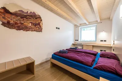 a kitchen with a table with glasses and wine bottles at Attico Elbetina in Campitello di Fassa