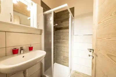 a room with two bunk beds and a window at Attico Elbetina in Campitello di Fassa