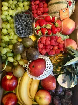 a display of fruits and vegetables on a table at Arya Alpine Lodge in Selva di Val Gardena