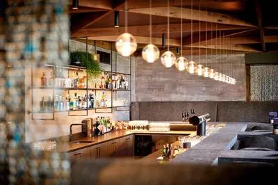 a bar in a restaurant with a counter with drinks at Hotel Das Sonnenparadies in Schenna