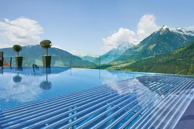 a swimming pool with a view of mountains at Hotel Das Sonnenparadies in Schenna