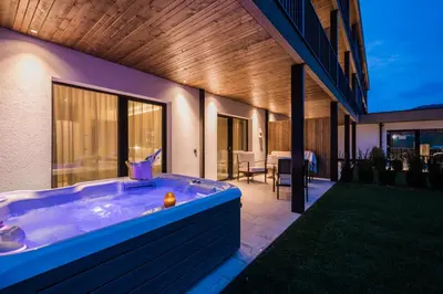a jacuzzi tub on the side of a house at K1 Mountain Chalet - Luxury Apartements in Brunico