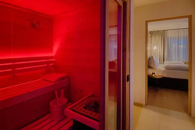a red bathroom with a red room with a bed at K1 Mountain Chalet - Luxury Apartements in Brunico