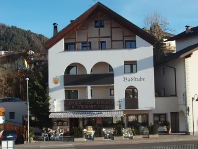 a large building with people sitting outside of it at Gasthof Toni in Castelrotto