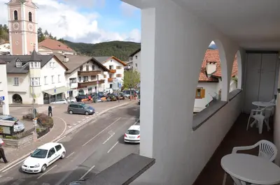 a balcony with a view of a city street at Gasthof Toni in Castelrotto