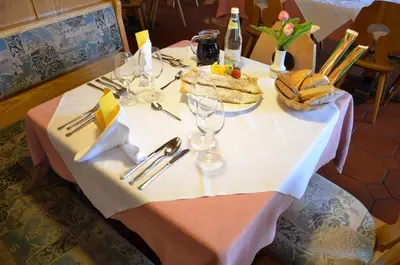 a table with a plate of food on top of it at Gasthof Toni in Castelrotto