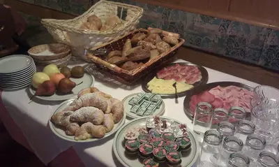 a table with different types of food on it at Gasthof Toni in Castelrotto
