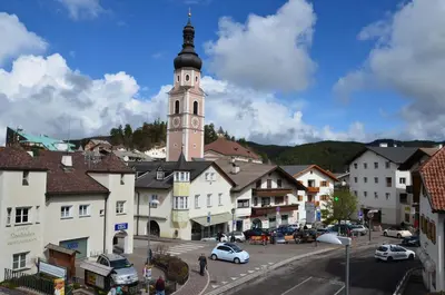 a town with a clock tower in the distance at Gasthof Toni in Castelrotto