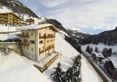a building on top of a snow covered mountain at Garni Bellavista in Arabba