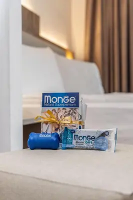 a couple of toothbrushes and a tube of money on a bed at Hotel Ramon in Campitello di Fassa