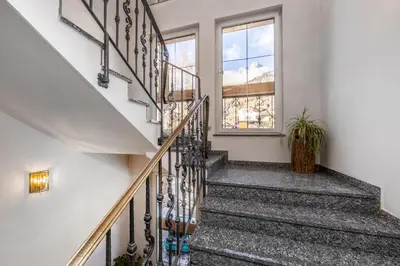 a staircase in a house with a window at Hotel Ramon in Campitello di Fassa