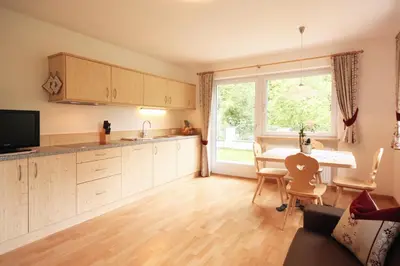 a kitchen and dining room with a table and a window at Villa Otto in Santa Cristina in Val Gardena