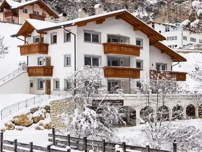 a house in the snow with a fence at Villa Otto in Santa Cristina in Val Gardena