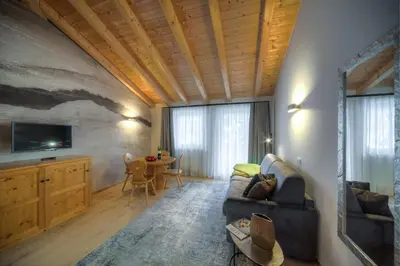 a living room with a couch and a table at Eden Apartments in Siusi