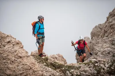 two people hiking on the side of a mountain at Lamondis in Castelrotto