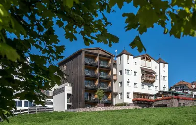an apartment building with a wooden facade at Lamondis in Castelrotto