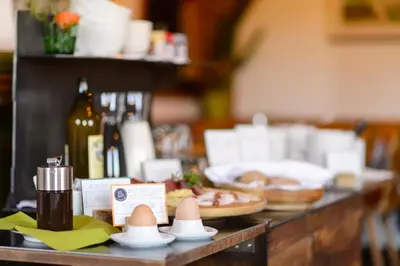 a counter with eggs and bottles of wine on it at Hotel Restaurant Waldbichl in Verano