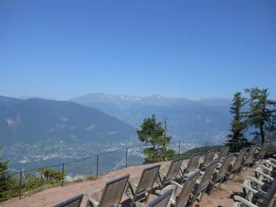 a row of chairs sitting on top of a hill at Hotel Restaurant Waldbichl in Verano