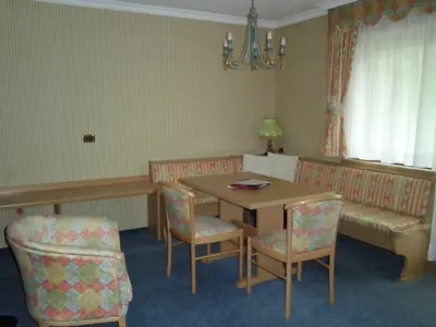 a bedroom with a large white bed and a window at Hotel Evaldo in Arabba