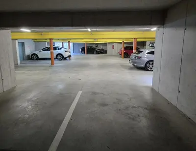 an empty parking garage with cars parked in it at Appartementhaus Am Waalweg in Rifiano
