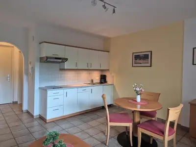 a kitchen and dining room with a table and chairs at Appartementhaus Am Waalweg in Rifiano