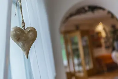 a wooden heart hanging on a door at Pension Prack in Brunico
