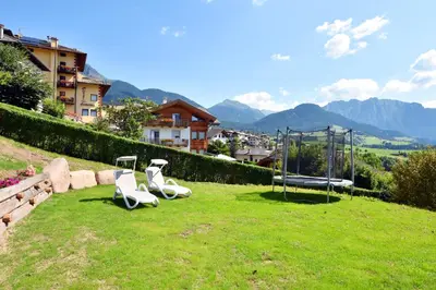 two chairs and a playground on a field of grass at BB le Fontanelle in Carano