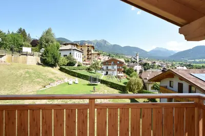 a view from a balcony of a town with mountains at BB le Fontanelle in Carano