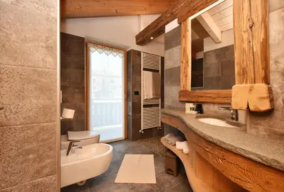 a bathroom with a sink and a toilet and a mirror at BB le Fontanelle in Carano