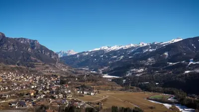 a small town in a valley with snow capped mountains at BB le Fontanelle in Carano