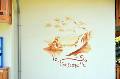 a wall with a painting of a woman on it at BB le Fontanelle in Carano