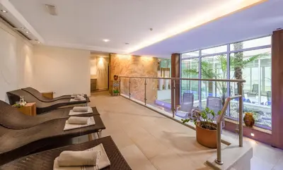 a hotel lobby with chairs and a balcony at Hotel Wilma in Nalles