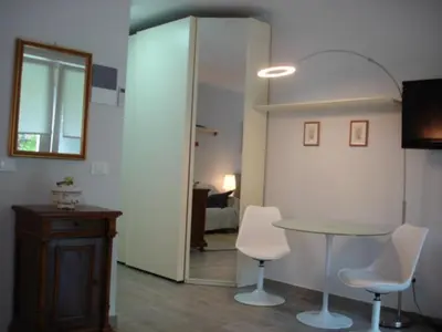 a room with a table and two chairs and a mirror at Nadia's Home in Merano