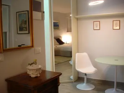 a room with a bedroom with a bed and a table at Nadia's Home in Merano