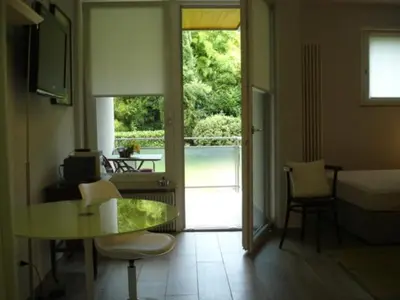 a living room with a table and a view of a porch at Nadia's Home in Merano