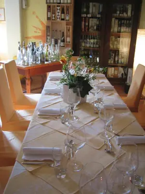 a long table with wine glasses and flowers on it at Parkhotel Post in Chiusa