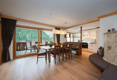 a kitchen and dining room with a table and chairs at Residence Sovara in Santa Cristina in Val Gardena