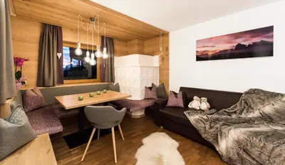 a living room with a couch and a table at Residence Sovara in Santa Cristina in Val Gardena