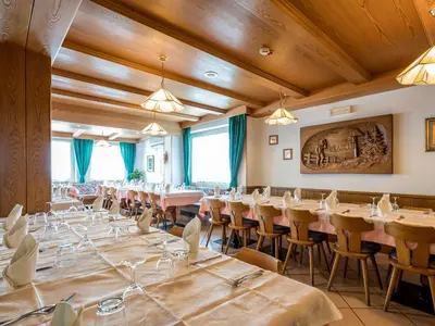 a bedroom with two beds and a window at Albergo Panorama in Panchia