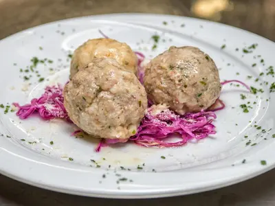 two meatballs on a white plate with red cabbage at Albergo Panorama in Panchia