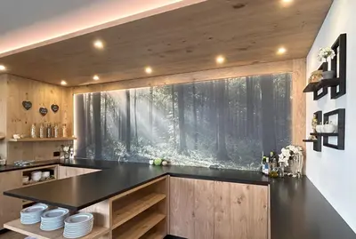 a kitchen with a black counter top and a window at Hotel Garni Walter in Ortisei