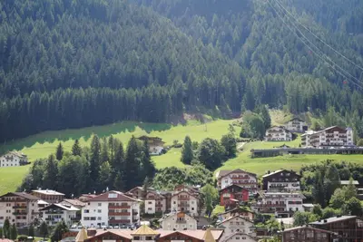 a small town in the mountains with houses and trees at Hotel Garni Walter in Ortisei