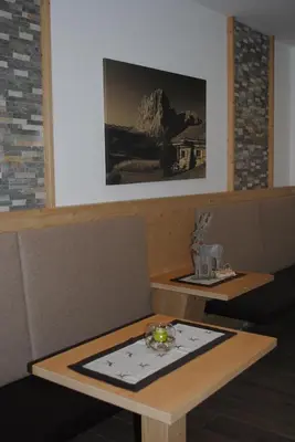 a table with a plate of food on top of it at Hotel Garni Walter in Ortisei