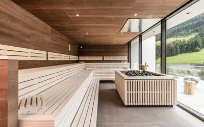 a tasting room with wood paneling and a large window at Hotel Seeber in Racines