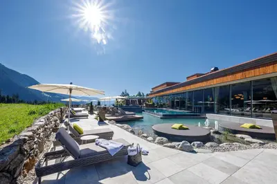 a resort with a pool and a building at Hotel Plunhof in Ridanna