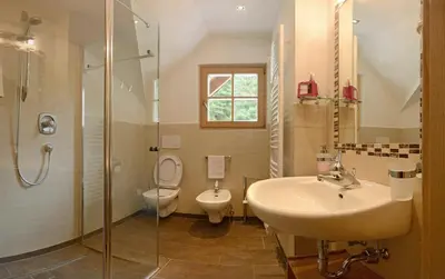 a bathroom with a sink and a toilet and a shower at B&B Appartments Cudlea in Selva di Val Gardena