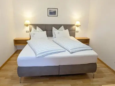 a bed in a room with two pillows on it at Residence Töglhof in Funes