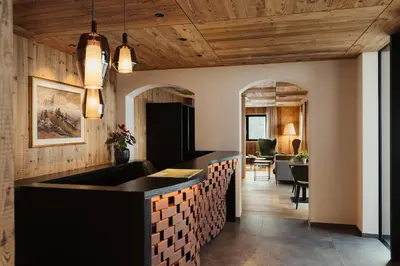 a kitchen with a black counter and wooden ceilings at Luxury B&B August in Ortisei